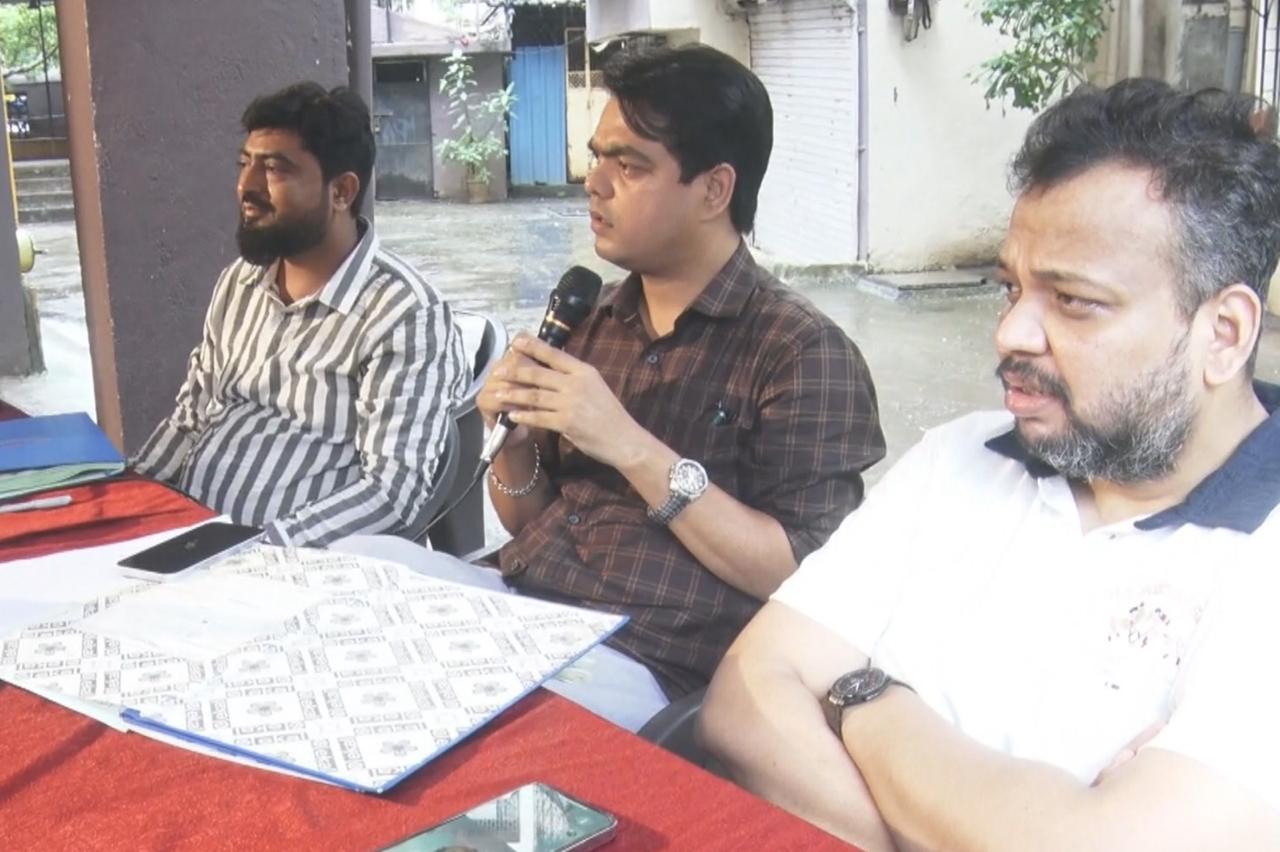Committee members addressing redevelopment questions at a society meeting